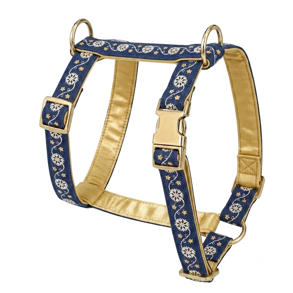 A navy blue dog harness with a white floral pattern and gold satin lining, featuring gold metal rings and buckles, shown on a plain white background.
