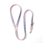A light blue dog leash with a pink and white gingham border, a pink and red strawberry pattern, and silver metal hardware, displayed on a clean white background.