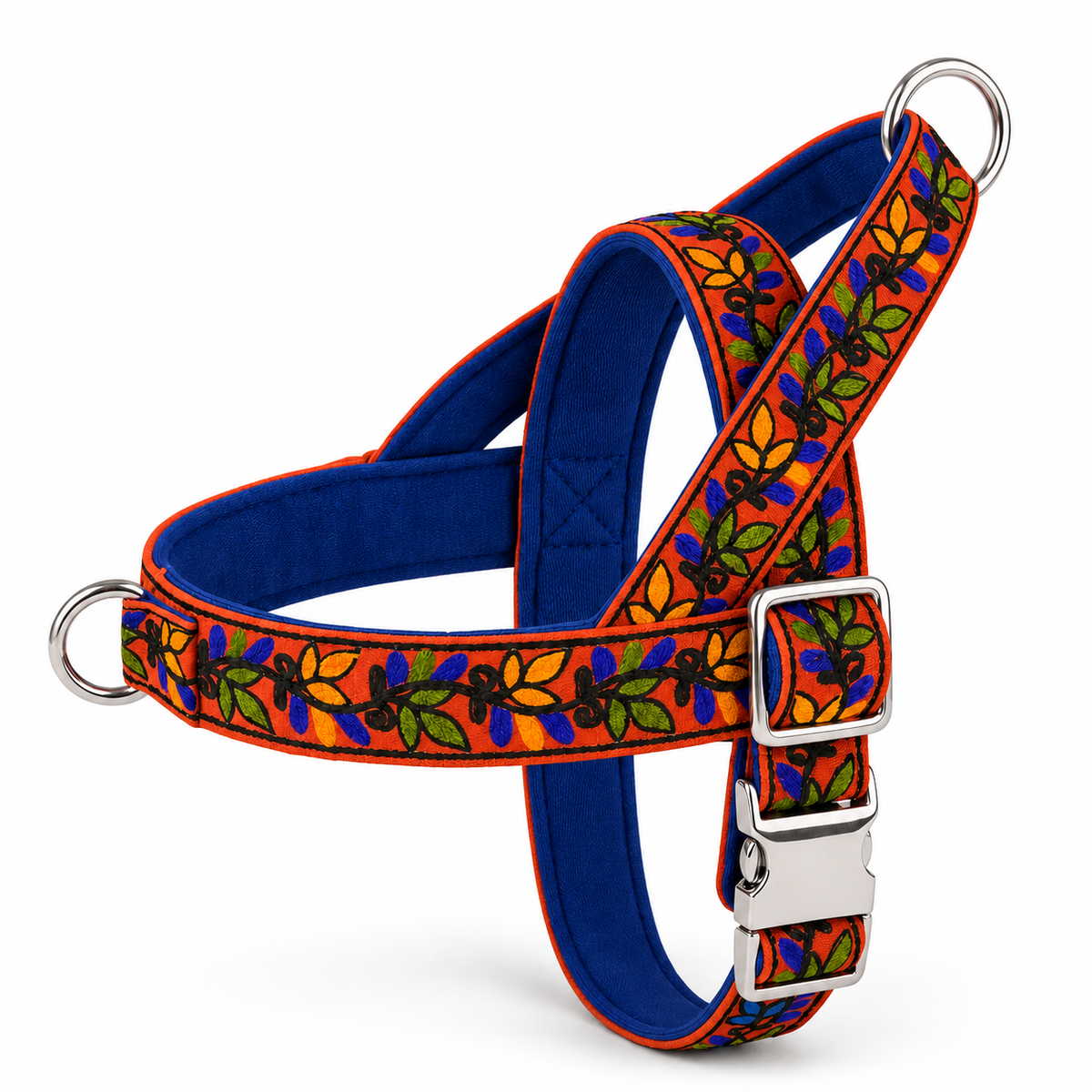 A dog harness with a vibrant orange and blue floral patterned fabric, a solid royal blue inner lining, and silver metal hardware including a quick-release buckle and D-rings, shown on a clean white background.