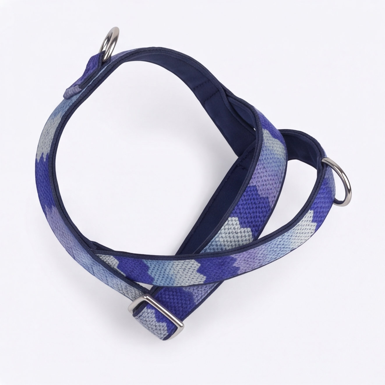 Blue patterned dog harness on a white background