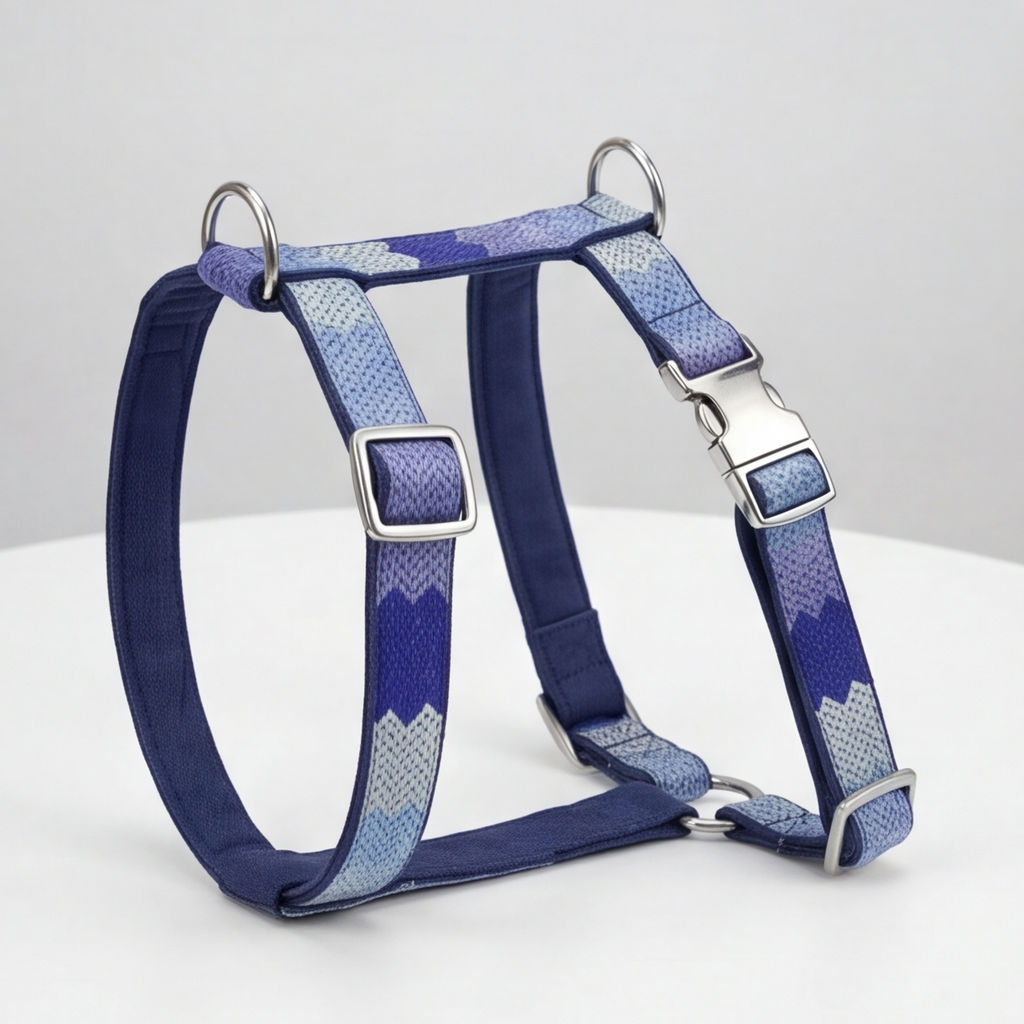 Blue and gray patterned dog harness on a white background