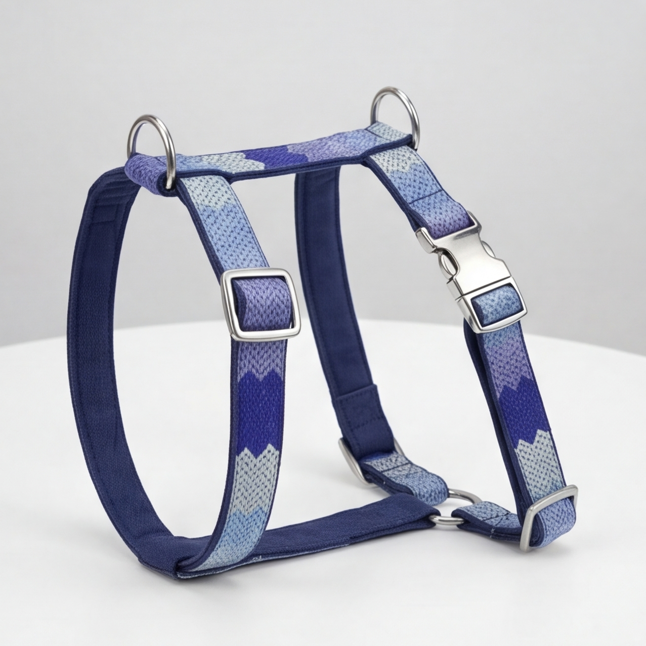 Blue and gray patterned dog harness on a white background