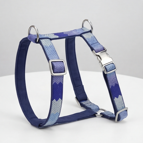 Blue and gray patterned dog harness on a white background