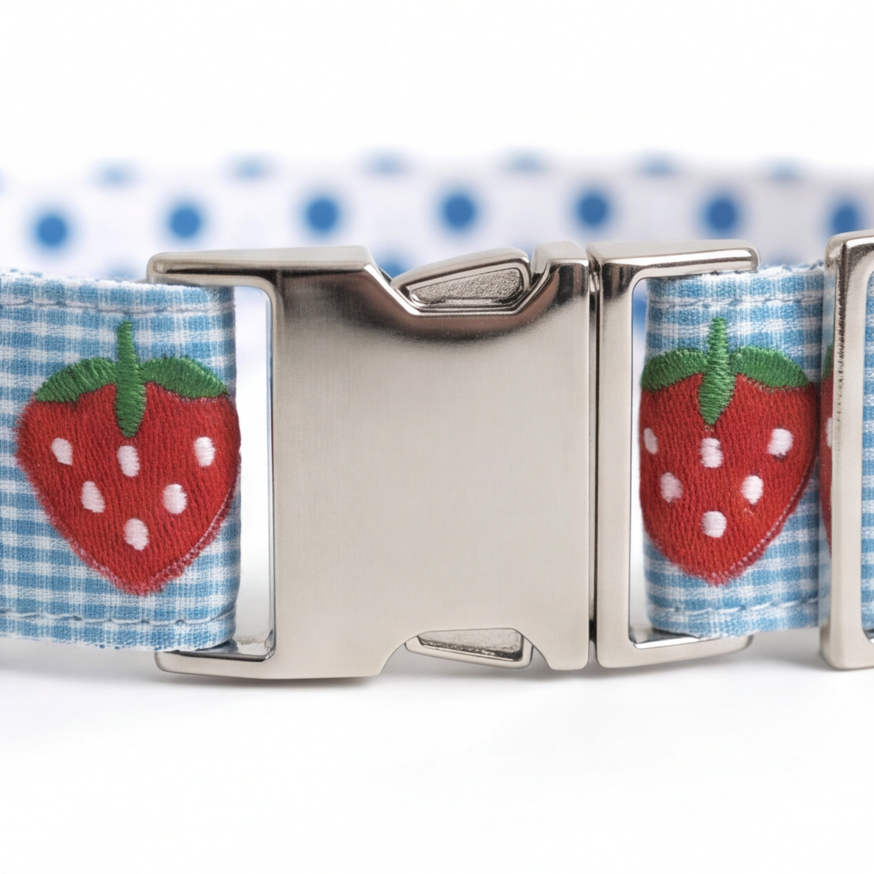 Dog collar with strawberry pattern and metal buckle on a white background