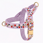 A lavender gingham dog harness with a strawberry and floral embroidered pattern, featuring gold-tone metal rings and a matching gold buckle.