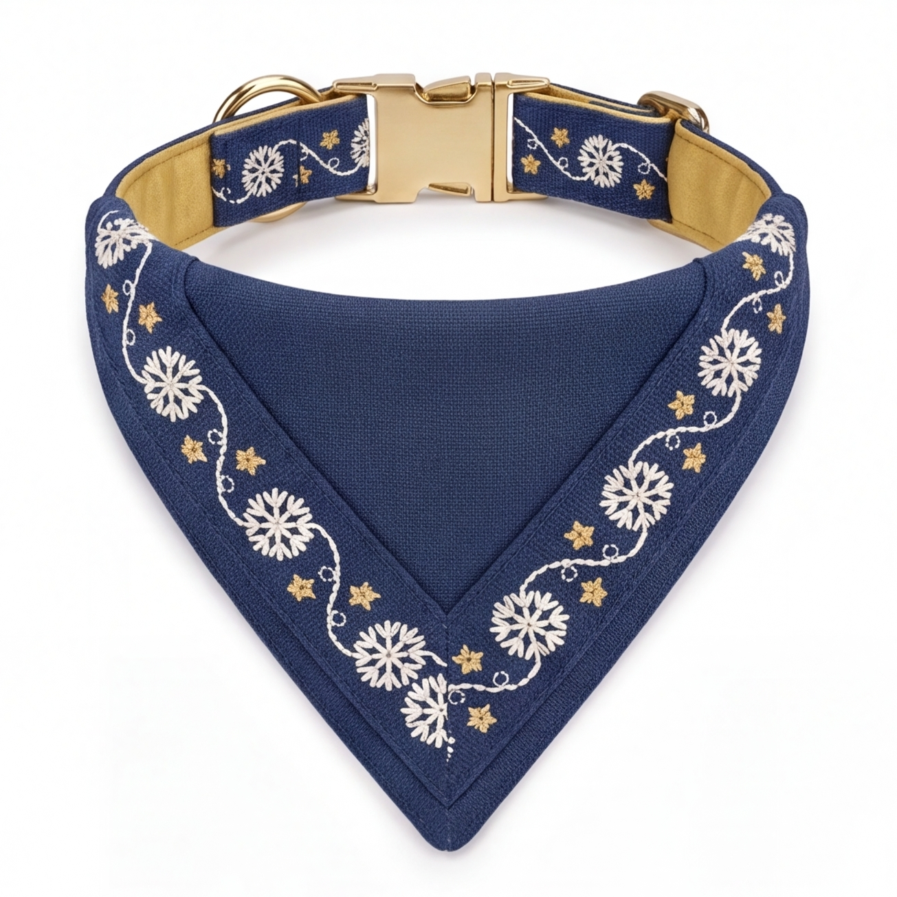 A navy blue triangular dog bandana with white floral embroidery and gold star accents, featuring a gold-tone metal buckle and a tan interior lining, shown on a white background.