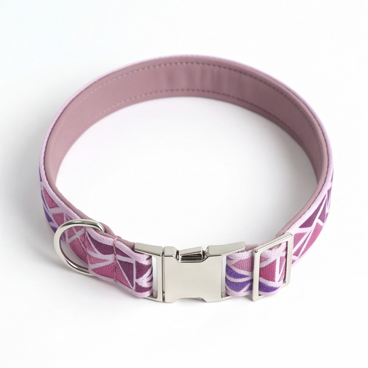 A pink and purple patterned dog collar with a silver metal buckle, photographed on a white background.