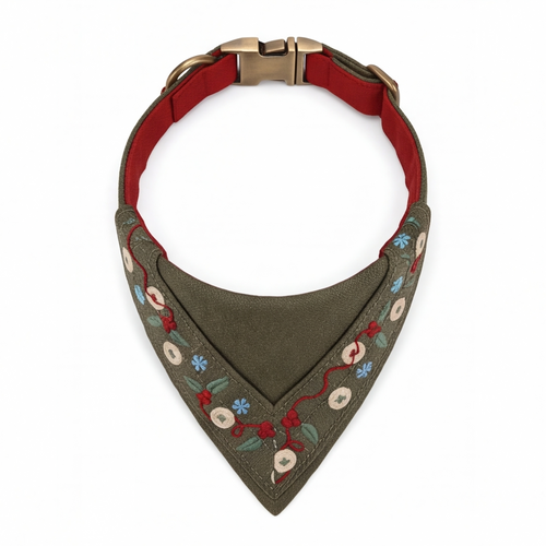 An olive green dog bandana collar with embroidered floral details and a red interior lining, shown on a white background.
